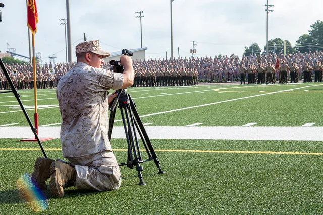 U.S. Marine Corps Staff Sgt. Albert Carls, a combat videographer with Marine Corps Installations East, Marine Corps Base Camp Lejeune Combat Camera, records the 4th Marine Division (4th MARDIV) Association deactivation ceremony at Liversedge Field, Camp Lejeune, N.C., Aug. 6, 2015. Veterans of 4th M. Videography training: what to cover and when